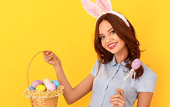 young female in bunny ears holding an egg basket